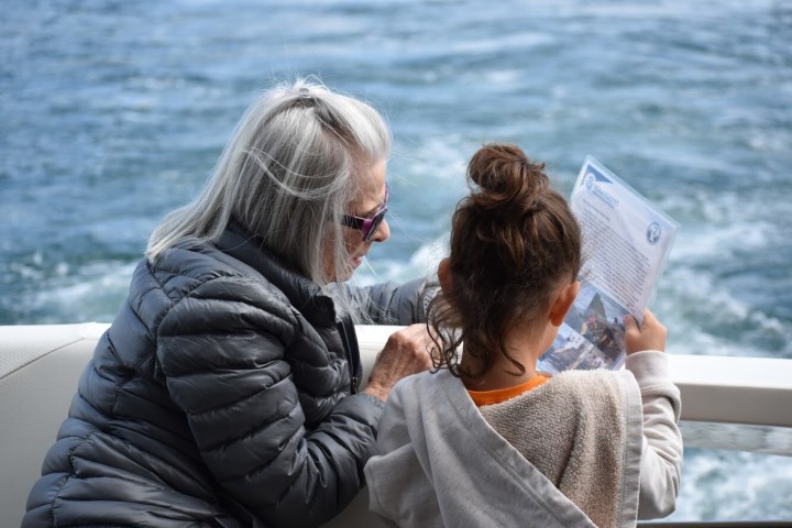 a man and a woman standing next to a body of water