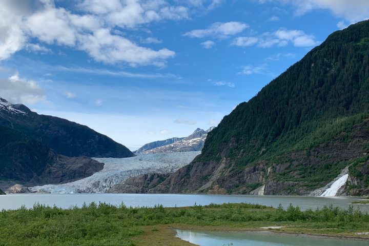 a body of water with a mountain in the background