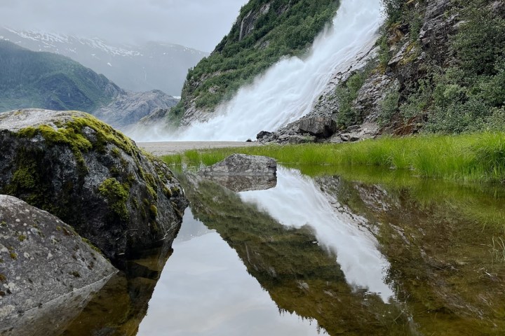 a waterfall with a mountain in the background
