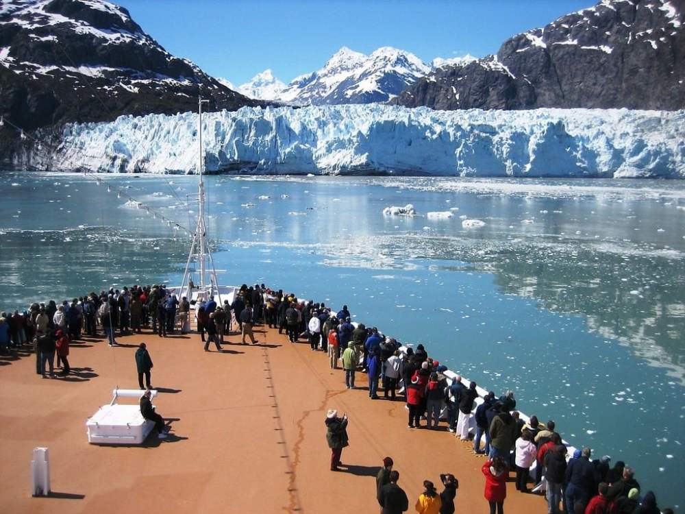 cruise ship passengers marveling at a glacier in Alaska