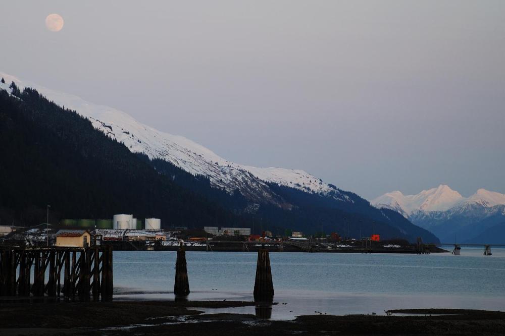 a body of water with a mountain in the background