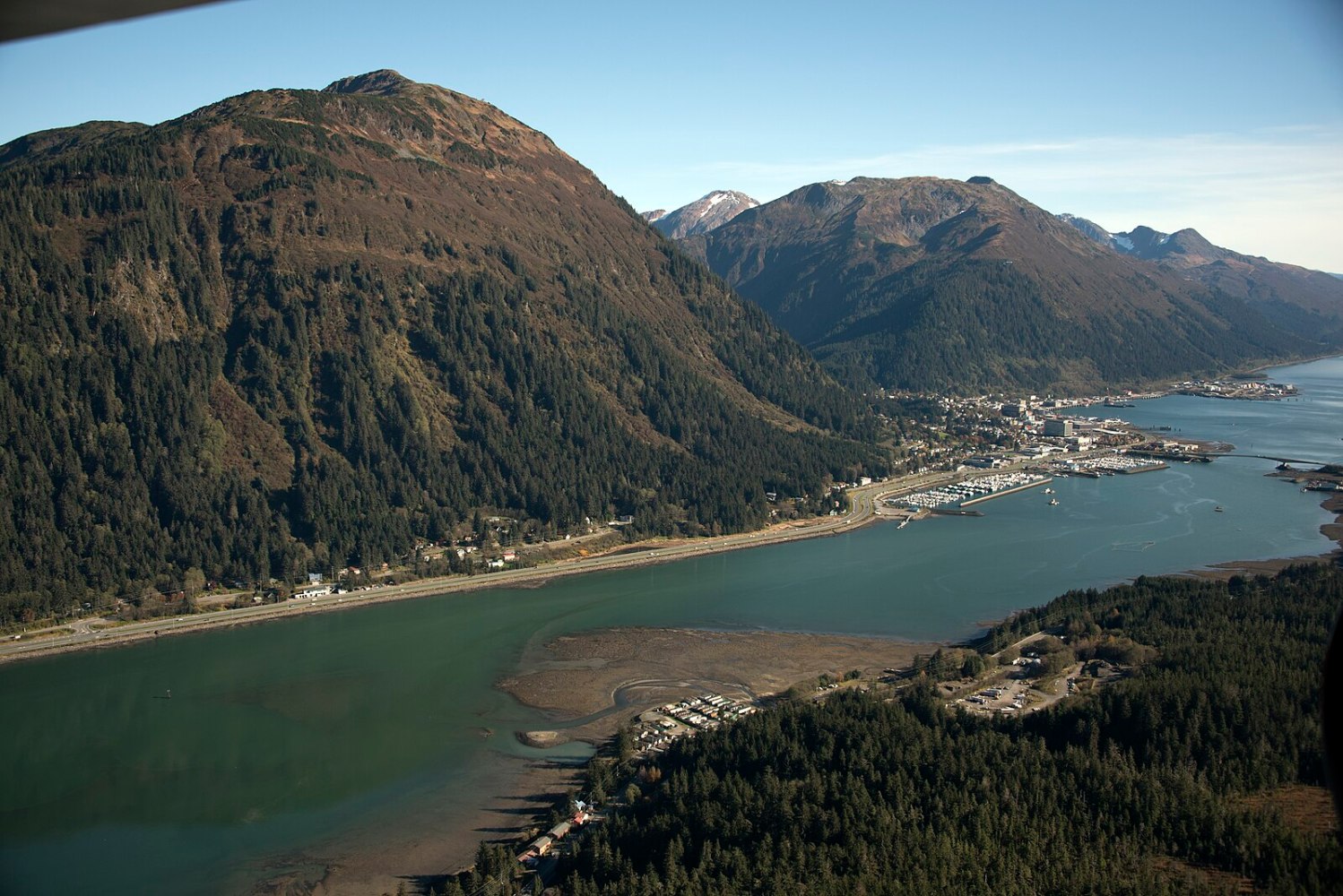 a body of water with a mountain in the background