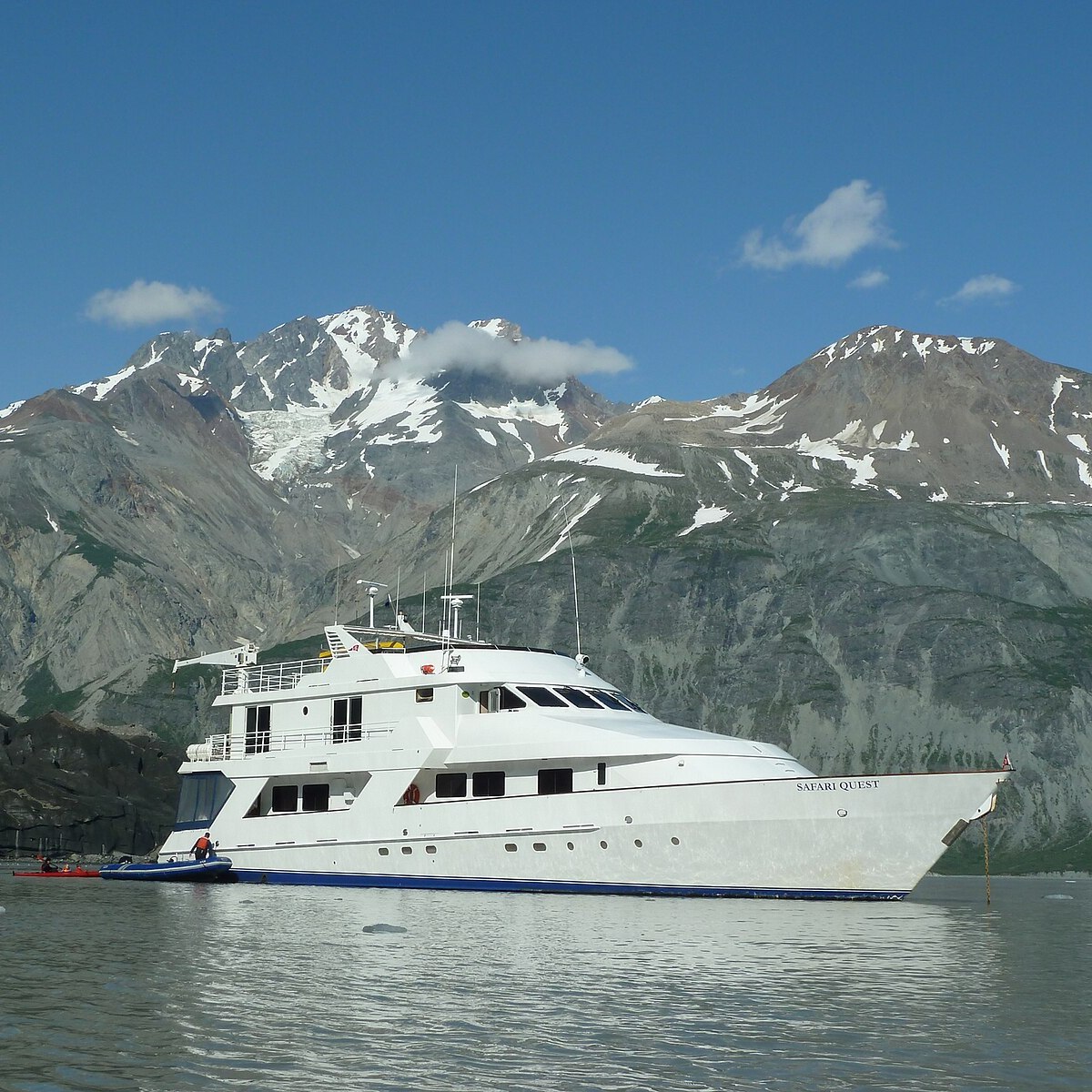 a boat in the water with a mountain in the background