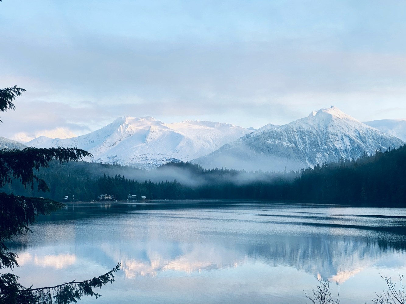 a body of water with a mountain in the background